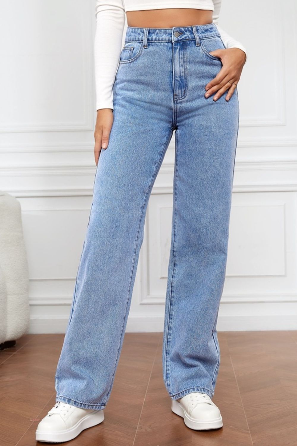 Light blue wide-leg denim jeans with a sculpted waist and button fly.