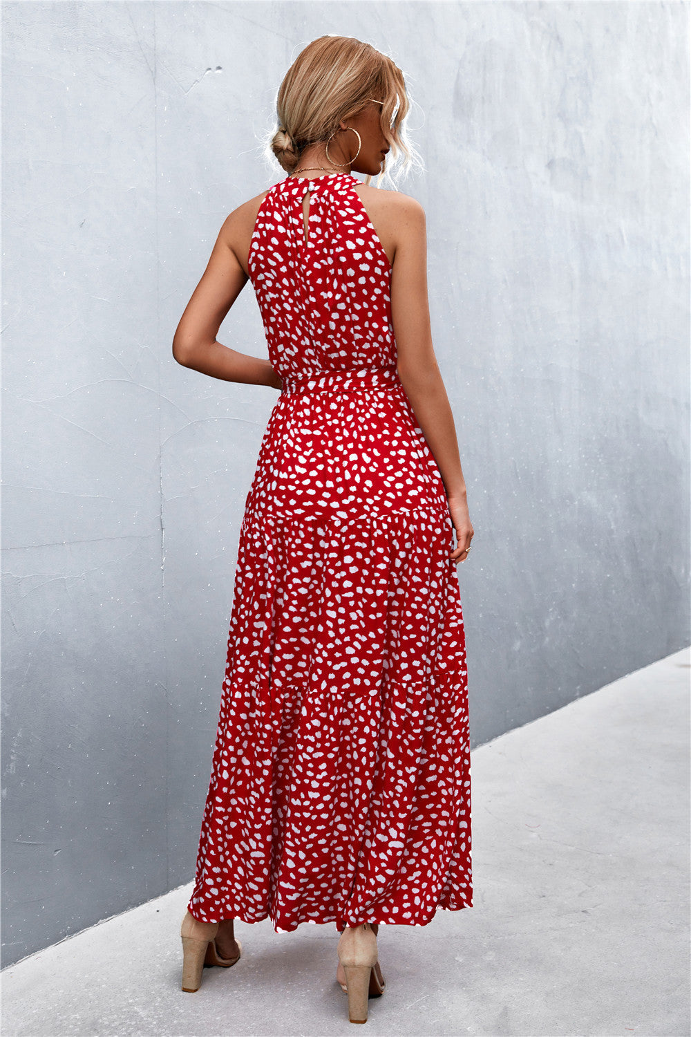 Red floral print maxi dress with halter neckline and tiered skirt.
