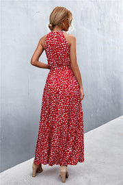 Red floral print maxi dress with halter neckline and tiered skirt.
