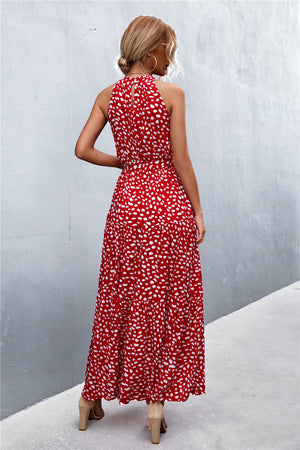Red floral print maxi dress with halter neckline and tiered skirt.