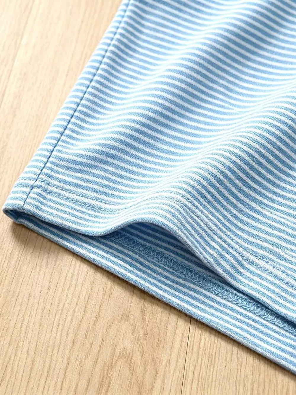 Baby blue and white striped cotton shorts with a rolled hem detail.