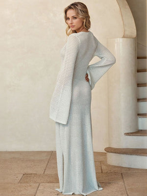 White crochet maxi dress with bell sleeves and a subtle slit, made of 100% polyester.