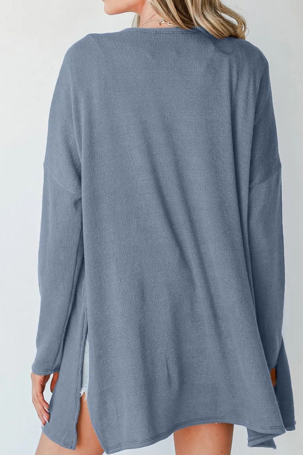 Dusty blue ribbed knit cardigan with side slits and long sleeves.