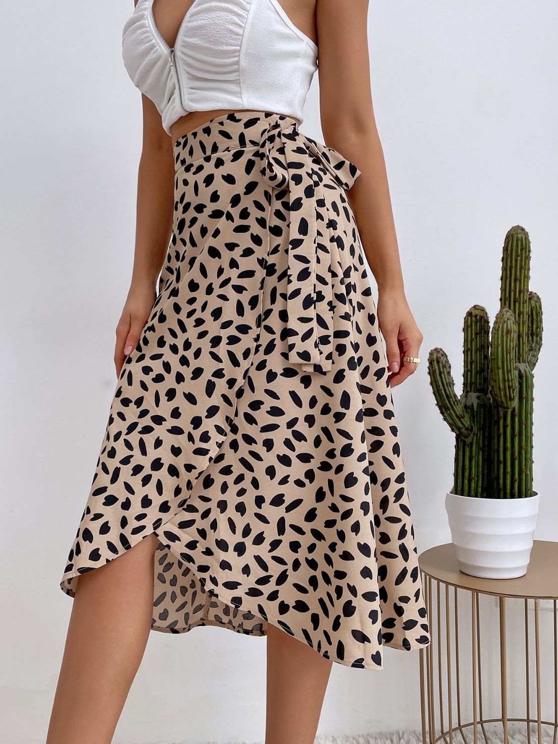 Tan asymmetric wrap skirt with abstract print and tie waist