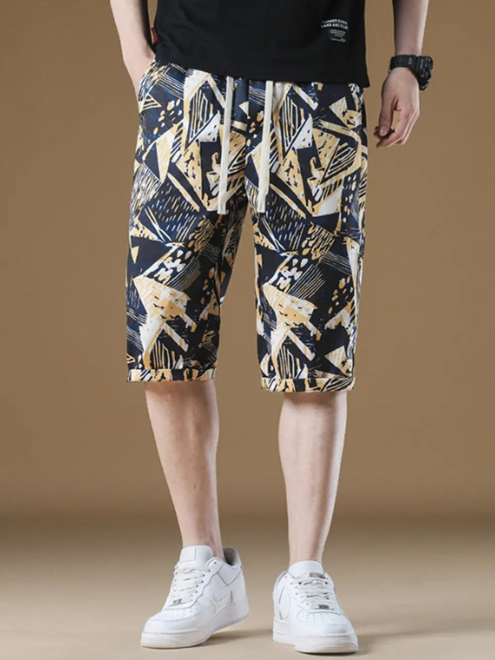 Men's geometric print chino shorts with drawstring waist and cuffed hem.