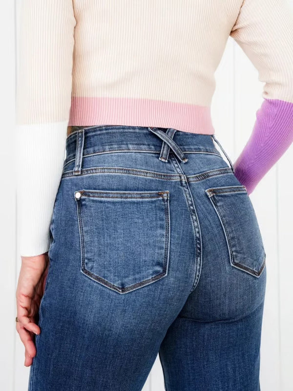 Medium wash denim jeans with utility pockets and wide leg cut.