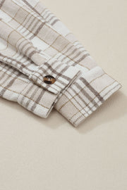 Oversized plaid shacket with attached hoodie, featuring a button cuff detail on the sleeve.