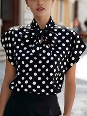 Black polka dot shirt with bow tie neck and cap sleeves