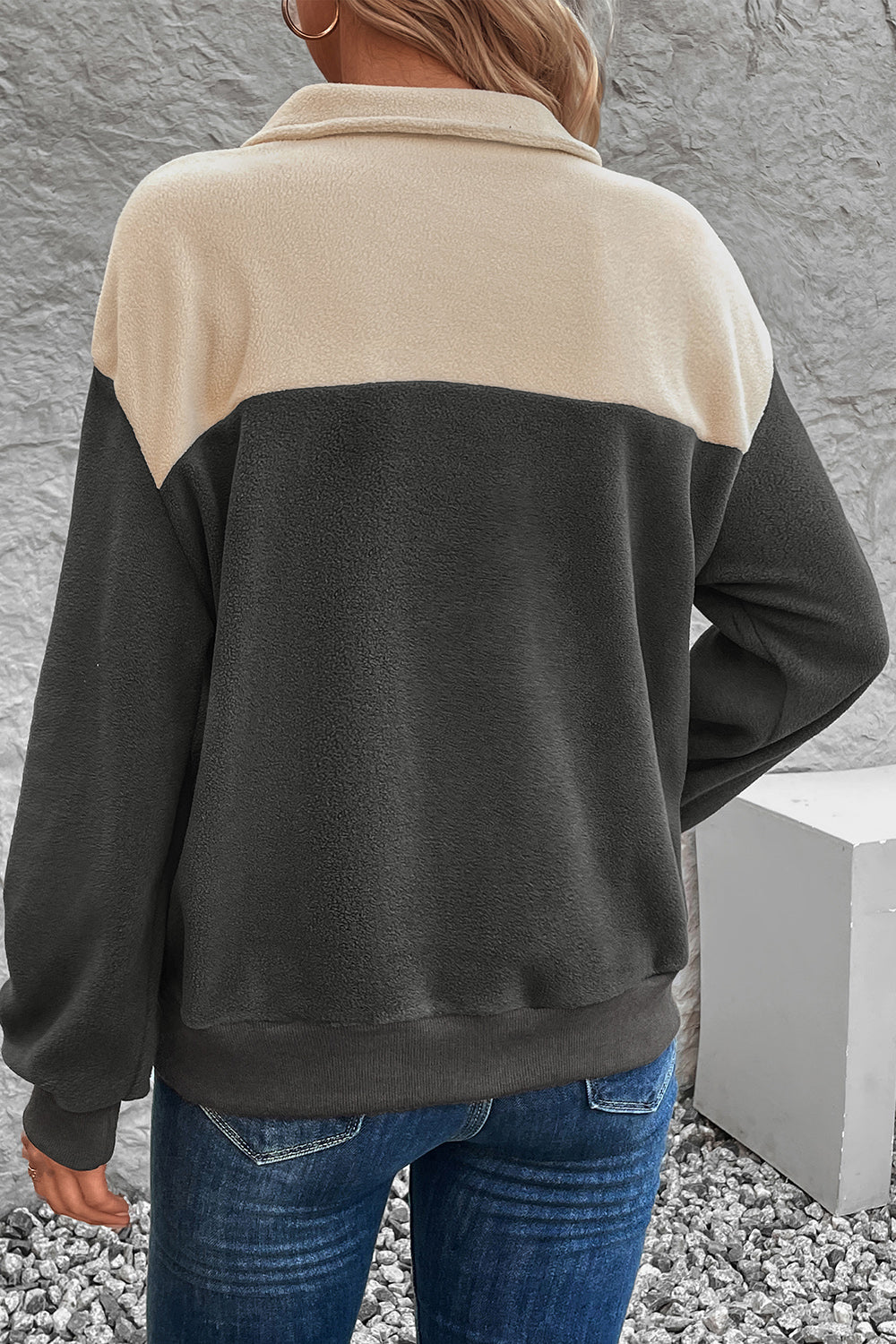 Colorblock fleece button-up pullover in dark gray and beige with a collared neckline.