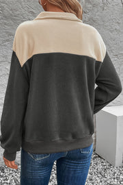Colorblock fleece button-up pullover in dark gray and beige with a collared neckline.
