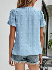 Blue textured puff sleeve dot blouse with short sleeves and a V-neck.
