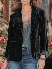 Black velvet blazer with rolled cuff detail and buttoned front, styled with a lace camisole and jeans.