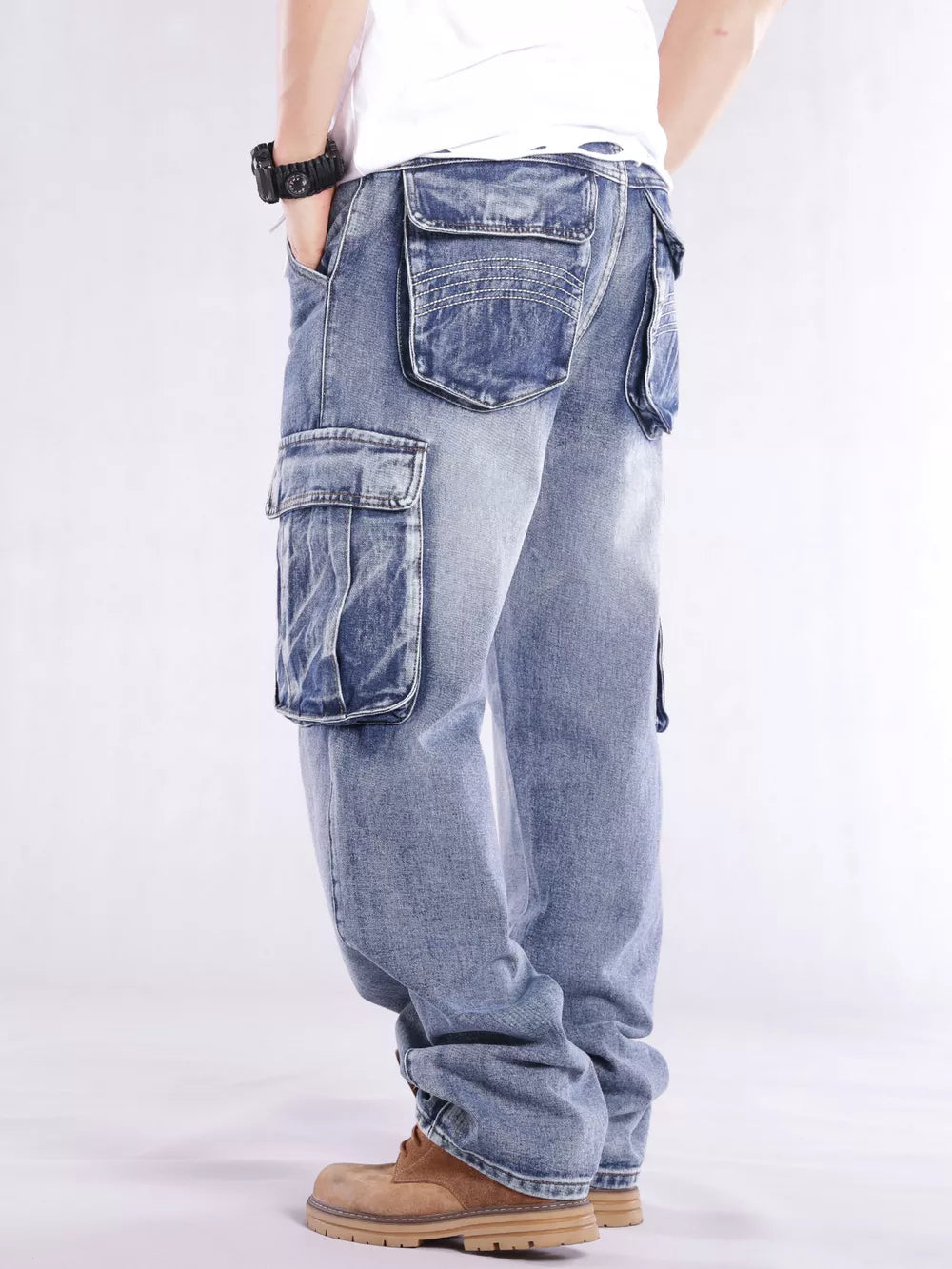 Relaxed fit light wash denim cargo jeans with flap pockets and contrast stitching.
