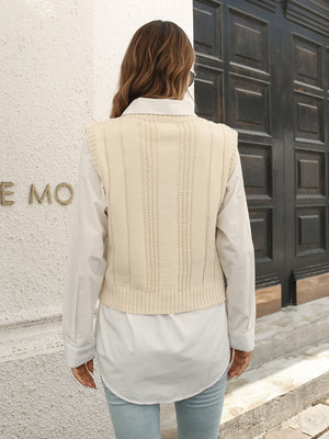 Ivory cable knit crop vest sweater with ribbed trim and vertical stitch detail.