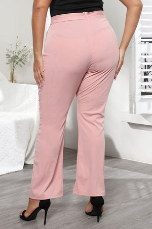 Dusty pink flare leg trousers with sculpted seams and a subtle texture.