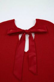 Red knit sweater with backless detail and satin bow tie closure
