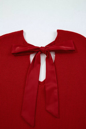Red knit sweater with backless detail and satin bow tie closure