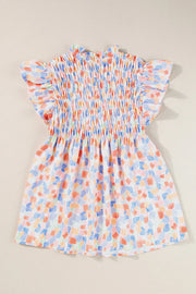 Smocked bodice blouse with brushstroke print and flutter sleeves in pastel colors.