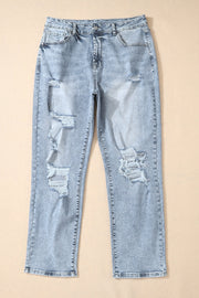 Light wash distressed denim jeans with a slim leg cut and ripped details.