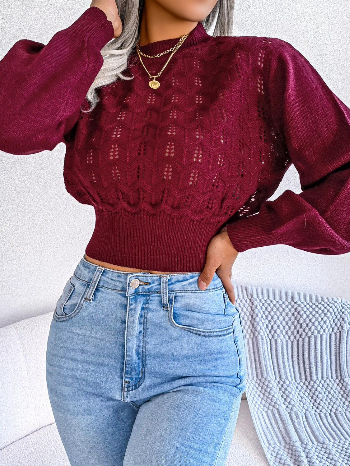 Burgundy openwork knit sweater with puff sleeves and mock neck, cropped length