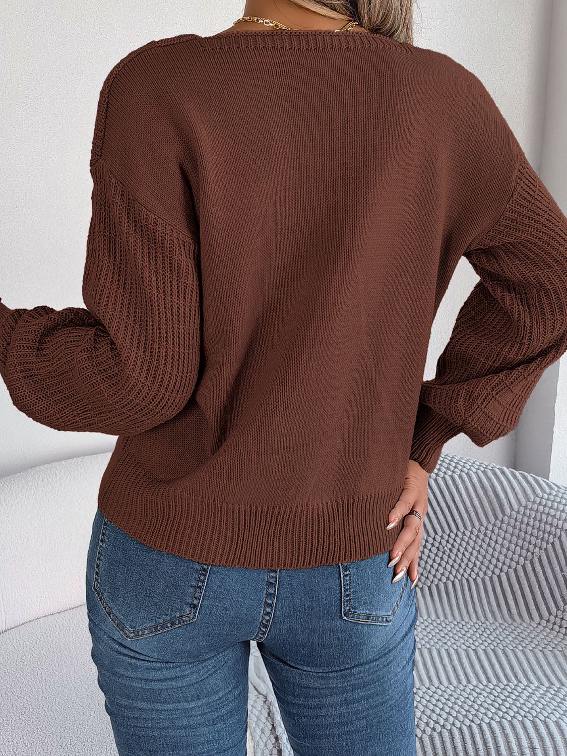Chocolate acrylic sweater with square neckline and textured sleeves.