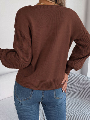 Chocolate acrylic sweater with square neckline and textured sleeves.