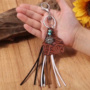 Leopard print tag charm keychain with flower, turquoise beads, and multi-color tassels.