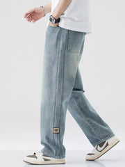 Men's light blue wide-leg jeans with drawstring waist and patch detail.