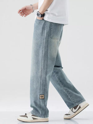 Men's light blue wide-leg jeans with drawstring waist and patch detail.