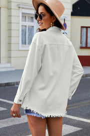 White oversized denim shirt jacket with frayed hem and button cuffs.