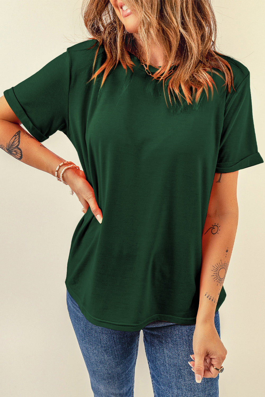 Dark green t-shirt with rolled short sleeves and a crew neck.