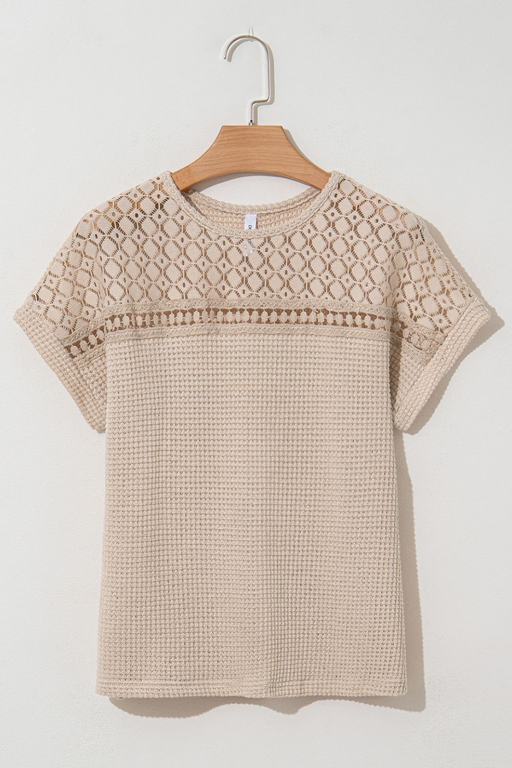 Beige waffle knit top with short sleeves and a lace yoke detail.