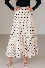 Chic polka dot maxi skirt in beige with a ruffled hem and subtle vertical stripes.