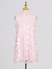 Pink ruffled floral applique mini dress with a mock neck and sleeveless design.