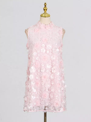 Pink ruffled floral applique mini dress with a mock neck and sleeveless design.