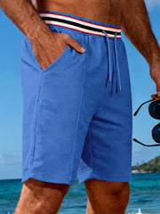 Blue textured chino shorts with drawstring and striped waistband detail.