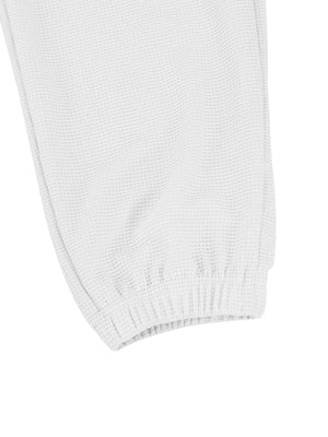 White waffle knit joggers with elastic cuffs and drawstring detail.