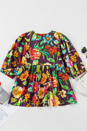 Embroidered floral babydoll blouse with puff sleeves and gathered waist.