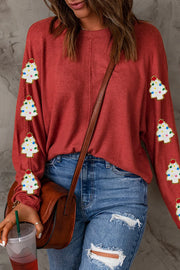 Scarlet sweater with embellished Christmas trees on sleeves.