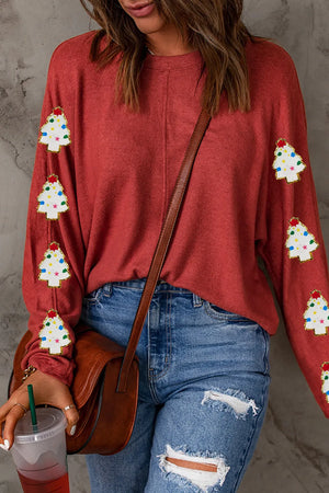 Scarlet sweater with embellished Christmas trees on sleeves.