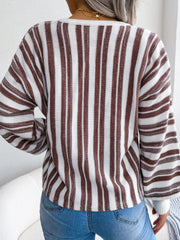 Striped knit cropped pullover sweater with a lace-up detail and long sleeves.