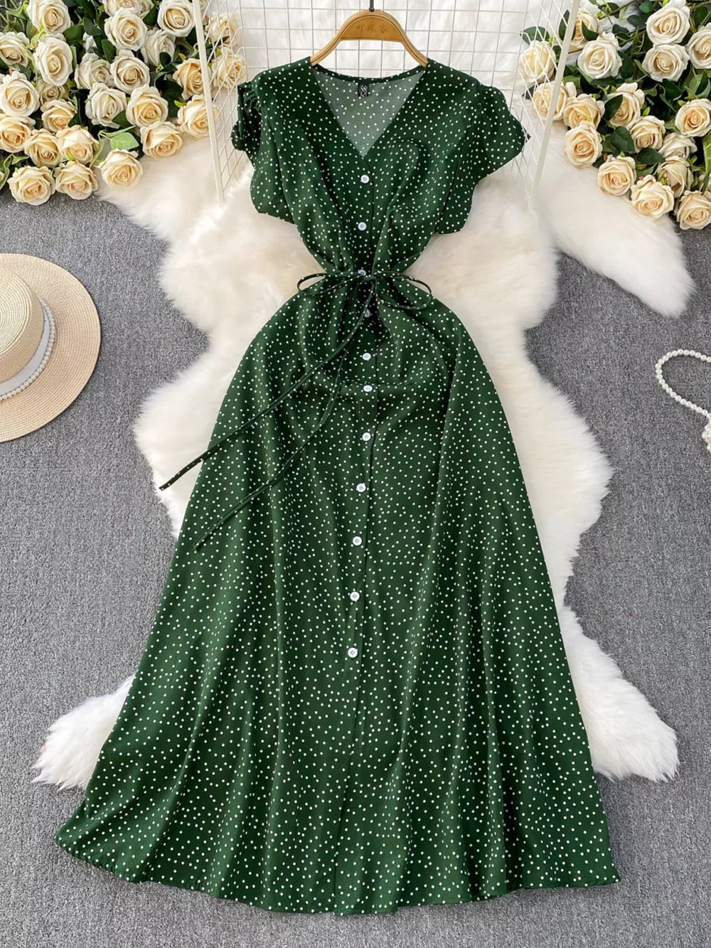 Green polka dot maxi dress with V-neck, button front, short sleeves, and belt.