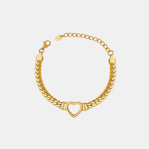 Gold curb chain bracelet with a hollow heart charm and adjustable clasp.