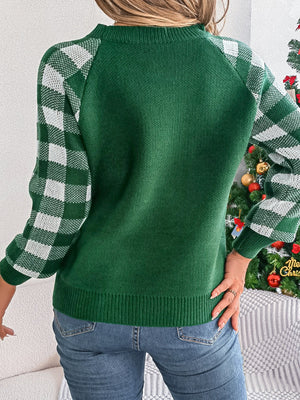 Dark green sweater with white gingham sleeves, crew neck, and ribbed trim.