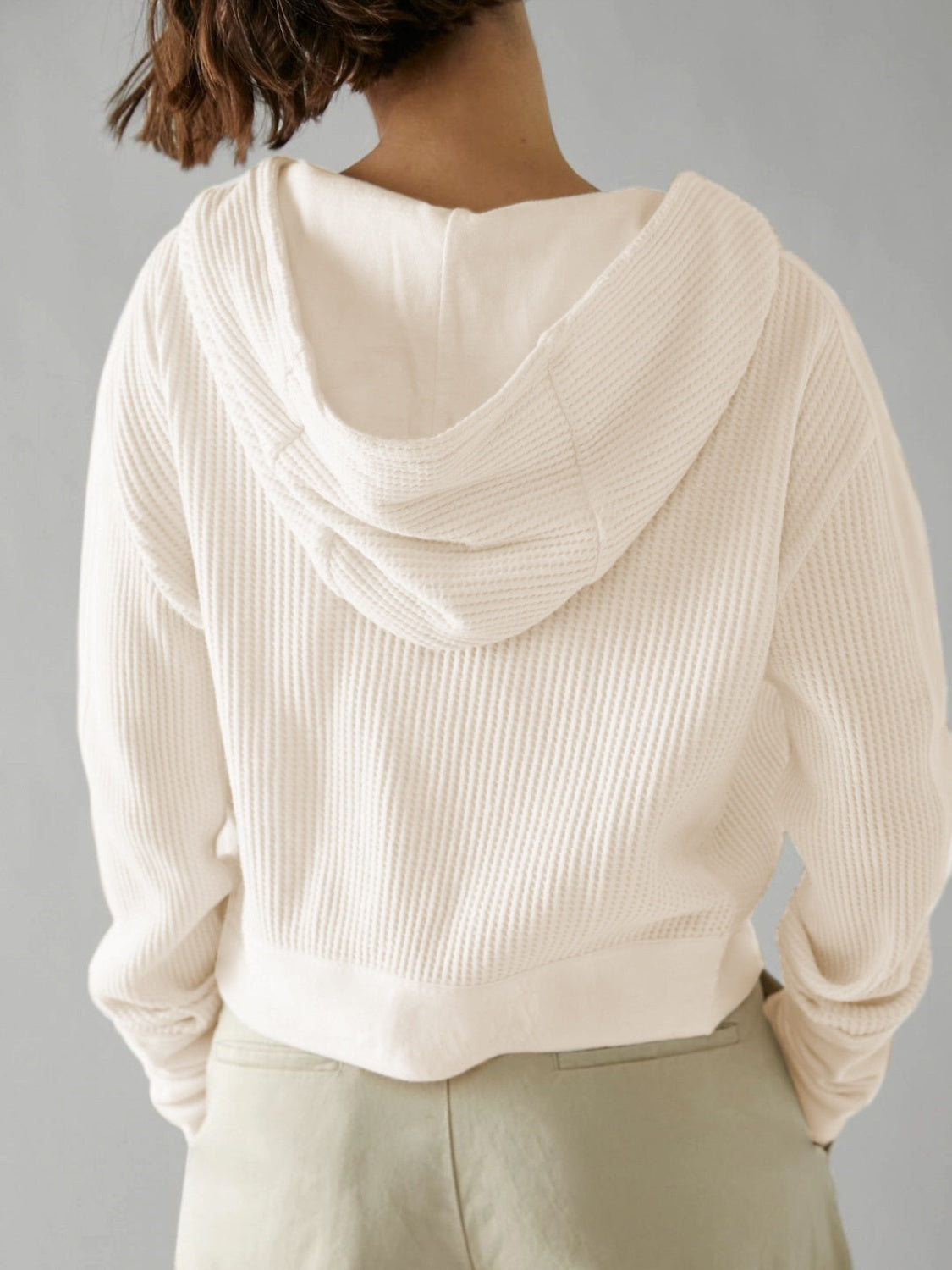 Cream waffle knit cropped hoodie with hood and snap front detail.