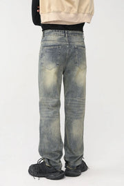 Distressed baggy denim jeans in medium wash with shredded knees and a casual fit.