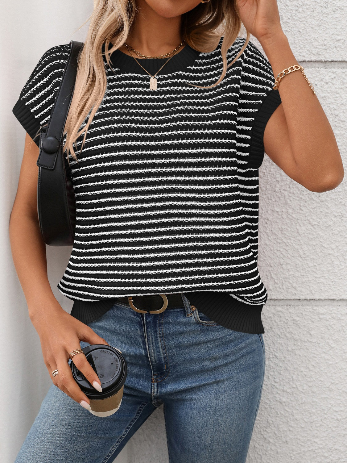 Black and white horizontal stripe knit shell top with short sleeves and crew neck.