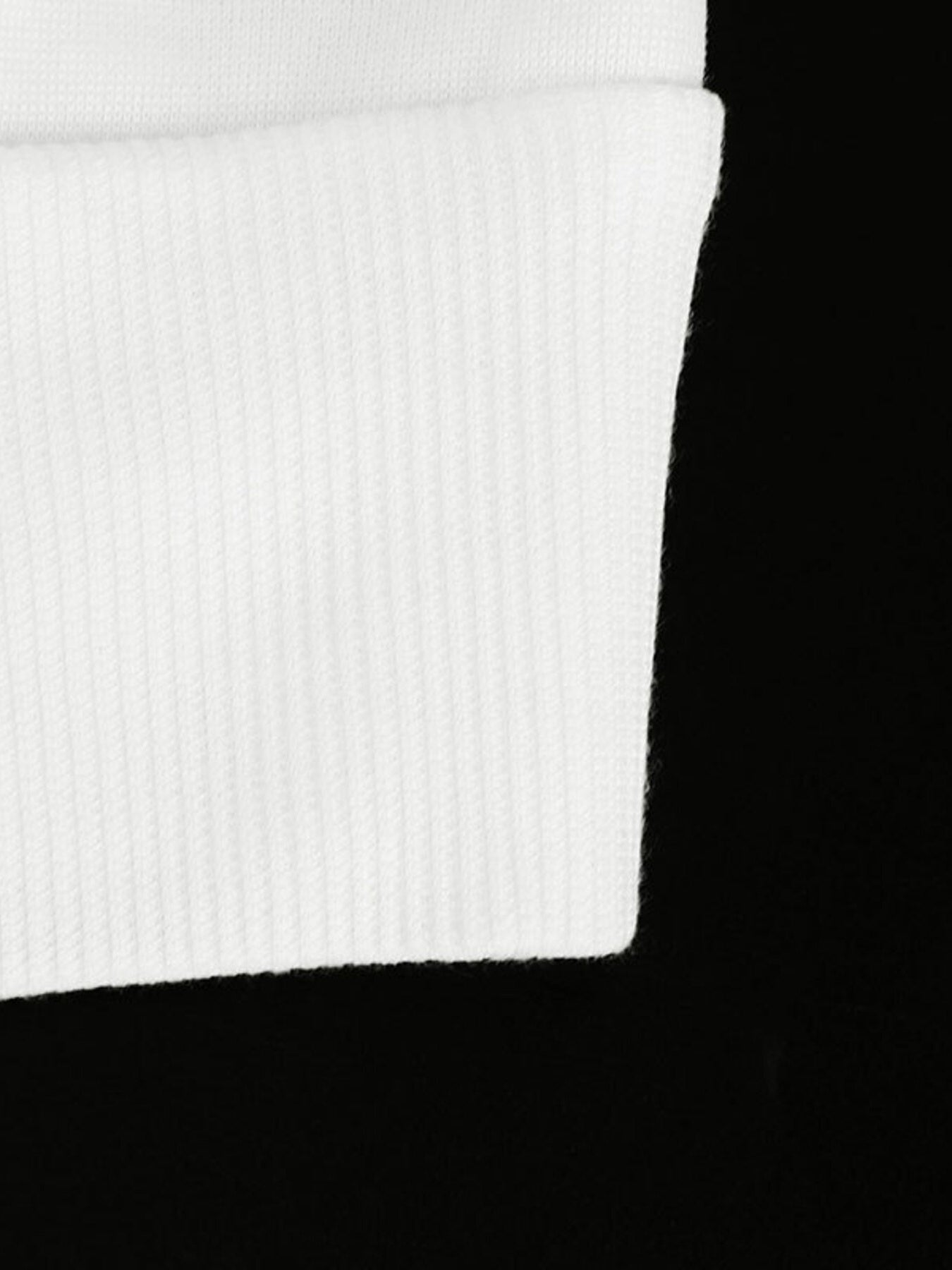 White ribbed fabric detail of a casual zip-up hoodie.