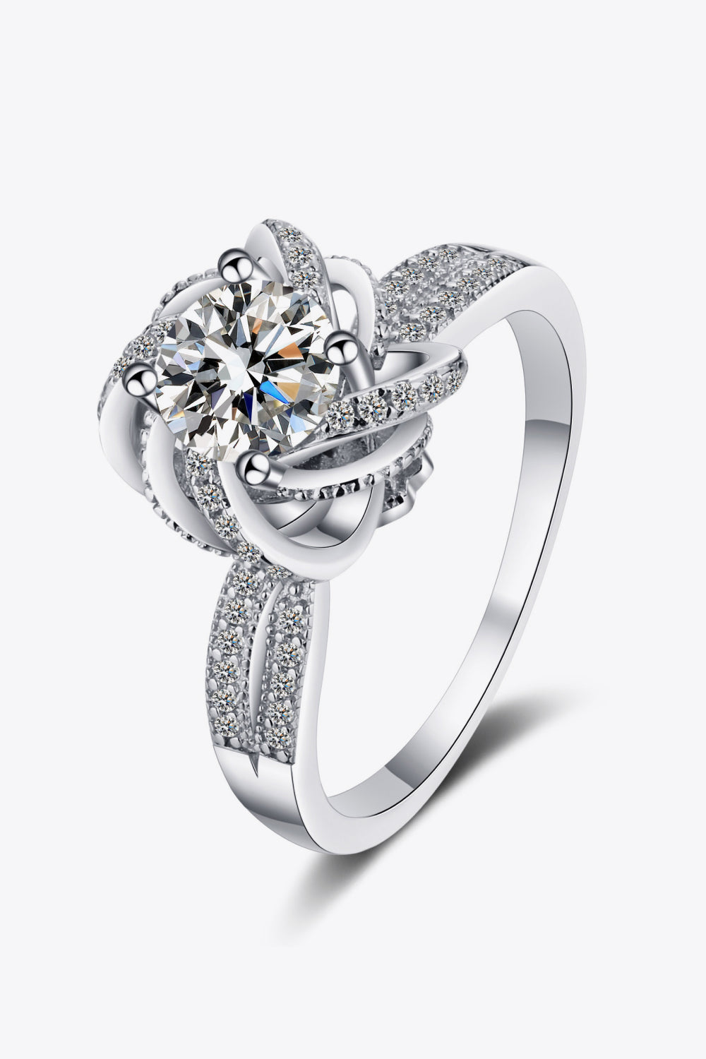 Silver ring with a floral halo moissanite center and pave diamond band.