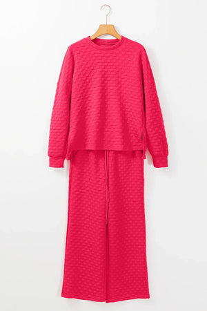 Textured weave lounge set in strawberry pink with crew neck sweatshirt and drawstring pants.